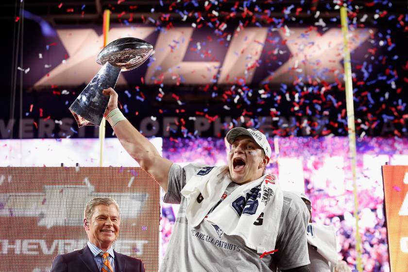 New England Patriots tight end Rob Gronkowski hoists the Lombari Trophy after the Patriots beat the Seattle Seahawks in Super Bowl XLIX.