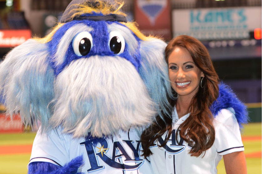 Golfer Holly Sonders poses with Raymond the mascot before throwing out a ceremonial 1st pitch as the Tampa Bay Rays host the Texas Rangers