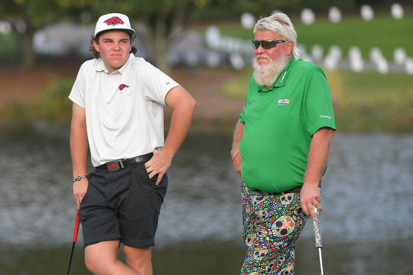 John Daly and his son, John Daly II stand together on the 18th green during the final round of the PGA TOUR Champions PNC Championship at Ritz-Carlton Golf Club