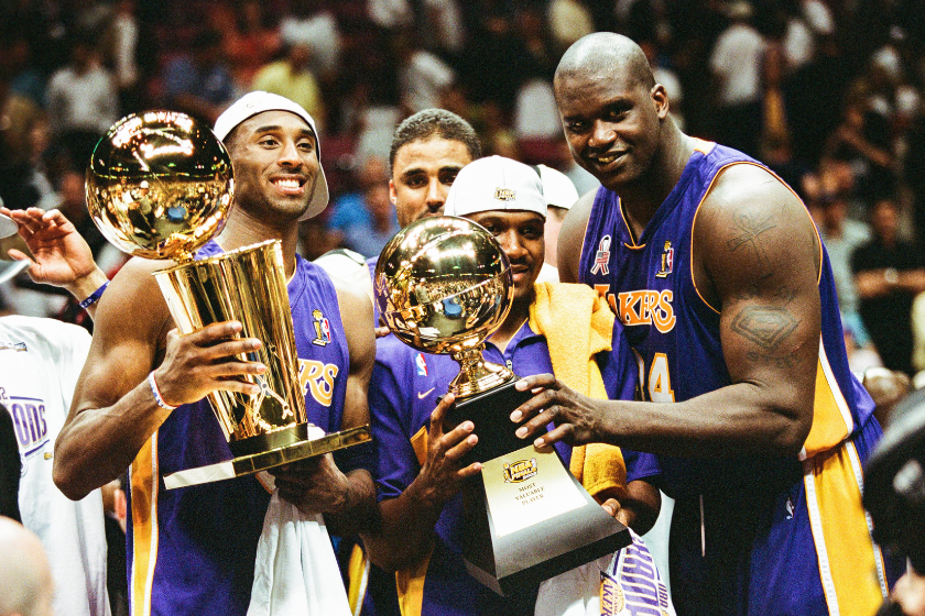 Kobe Bryant, Lindsey Hunter and Shaquille O'Neal of the Los Angeles Lakers celebrate following Game Four of the NBA Finals against the New Jersey Nets