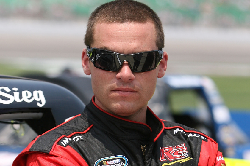 Shane Sieg stands on the grid prior to the NASCAR Camping World Truck Series O'Reilly Auto Parts 250 at Kansas Speedway on June 4, 2011