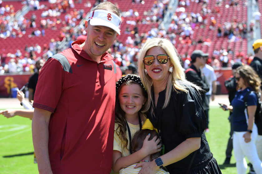 Head coach Lincoln Riley of the USC Trojans takes a photo with his wife and daughters following the 2022 USC Spring Football game