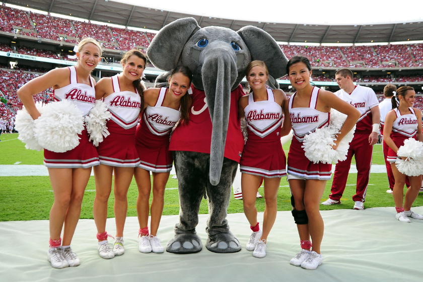 Big Al, the Crimson Tide Mascot, poses with cheerleaders during an Alabama game against Western Kentucky
