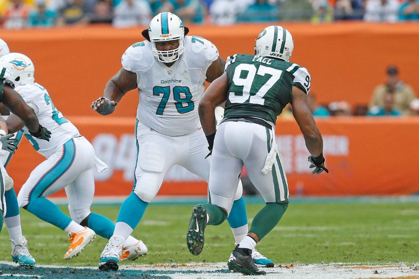 Miami Dolphins offensive lineman blocks against the New York Jets in 2013.