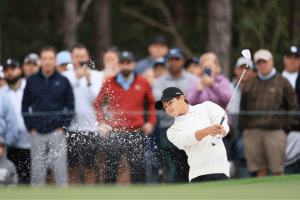 Charlie Woods plays a bunker shot during a rpactice round of the 2022 PNC Championship.