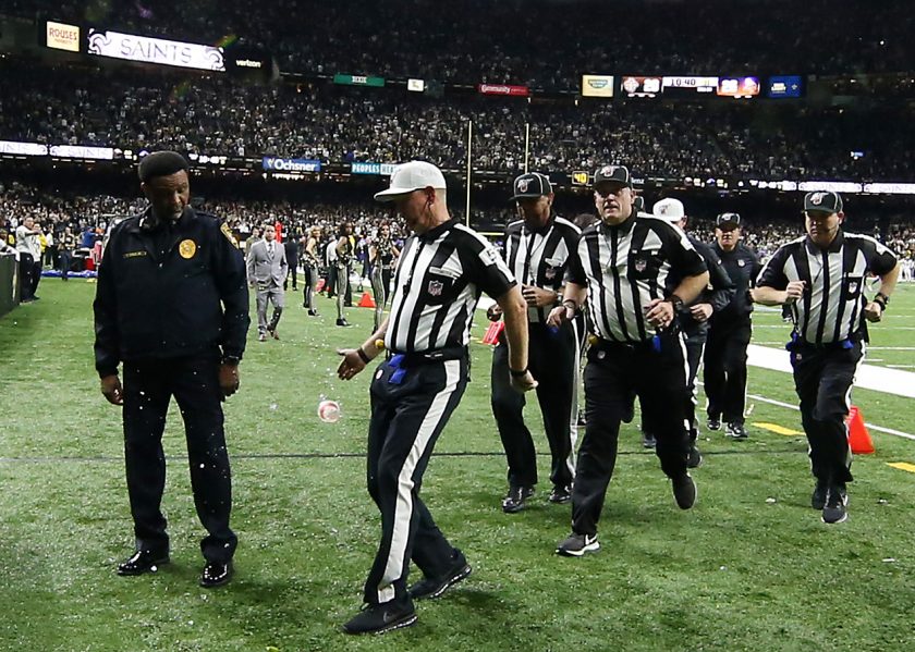 NFL referees leave the field after a Vikings-Saints game in 2020.