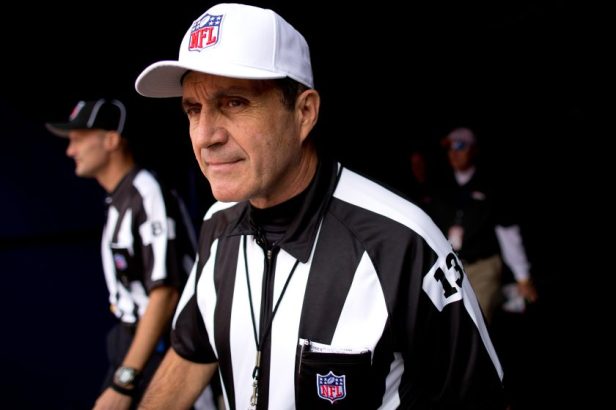 Referee Pete Morelli walk out of the tunnel towards the field before a game between the Oakland Raidersand Denver Broncos at Sports Authority Field Field at Mile High.