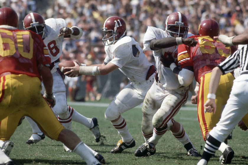 Alabama center Dwight Stephenson (57) in action, blocking for QB Jeff Rutledge (11) during game vs USC at Los Angeles Memorial Coliseum.