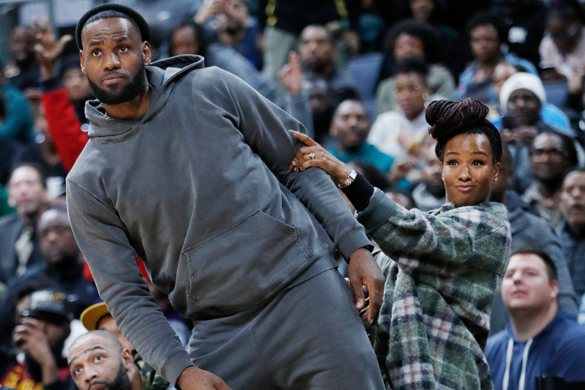LeBron James of the Los Angeles Lakers and wife Savannah James react while watching Sierra Canyon High School during the Ohio Scholastic Play-By-Play Classic against St. Vincent-St. Mary High School