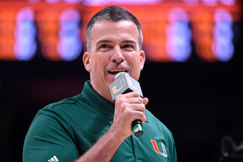 Miami head coach Mario Cristobal speaks at a basketball game.