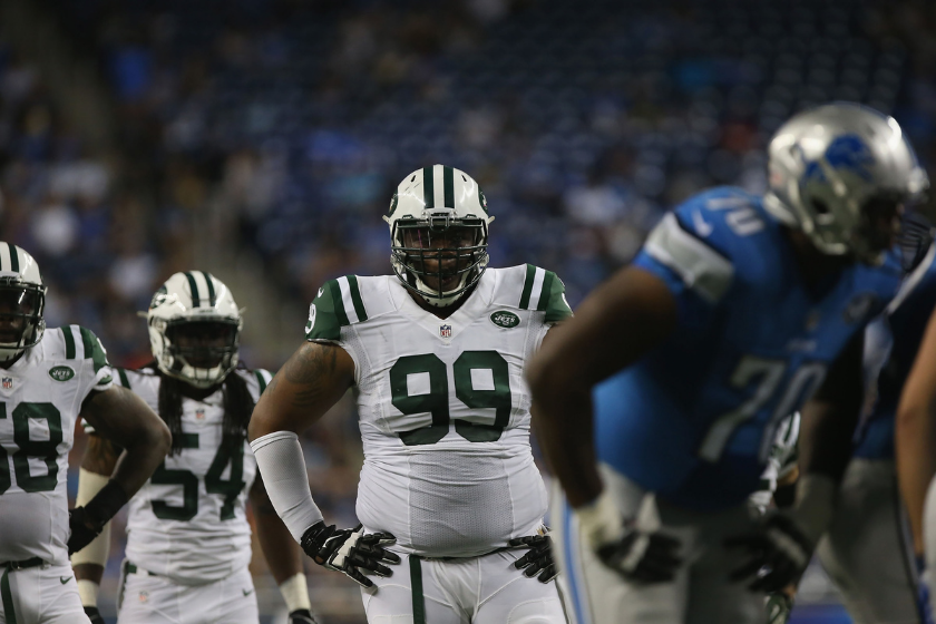 New York Jets defensive tackle prepares for a play against the Detroit Lions.
