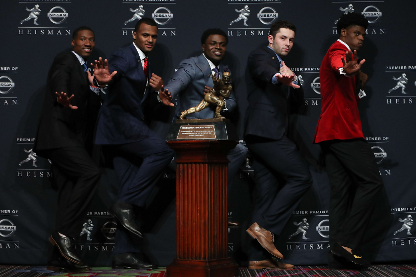  Dede Westbrook of the Oklahoma Sooners, Deshaun Watson of the Clemson Tigers, Jabrill Peppers of the Michigan Wolverines, Baker Mayfield of the Oklahoma Sooners and Lamar Jackson of the Louisville Cardinals pose for a photo with the Heisman trophy during a press conference prior to the 2016 Heisman Trophy Presentation