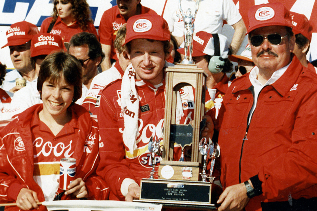 Bill Elliott and his car owner Harry Melling are joined by Melling's sons Matt and Mark after Elliott won the 1985 Daytona 500