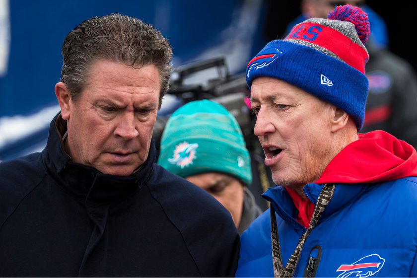  Hall of Fame quarterbacks Dan Marino (left) and Jim Kelly (right) talk before the game between the Buffalo Bills and the Miami Dolphins at New Era Field 