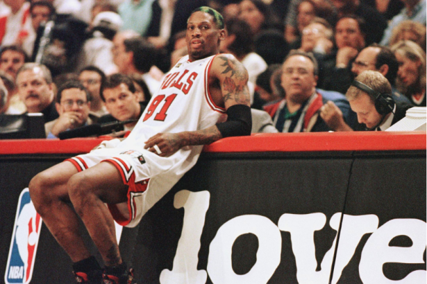 Dennis Rodman leans on the scorer's table in game four of the NBA Finals