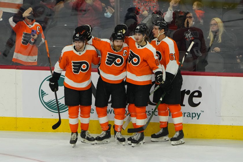 Philadelphia Flyers players gather during a game.
