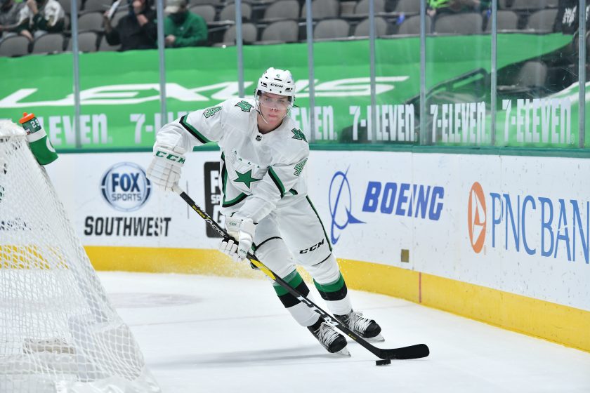 A Dallas Stars player passes the puck during a game.