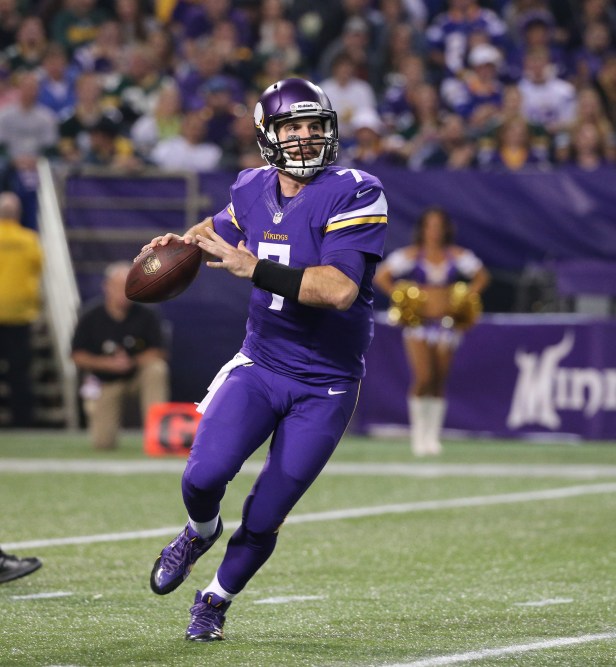 A Minnesota Vikings quarterback looks to pass during a game.