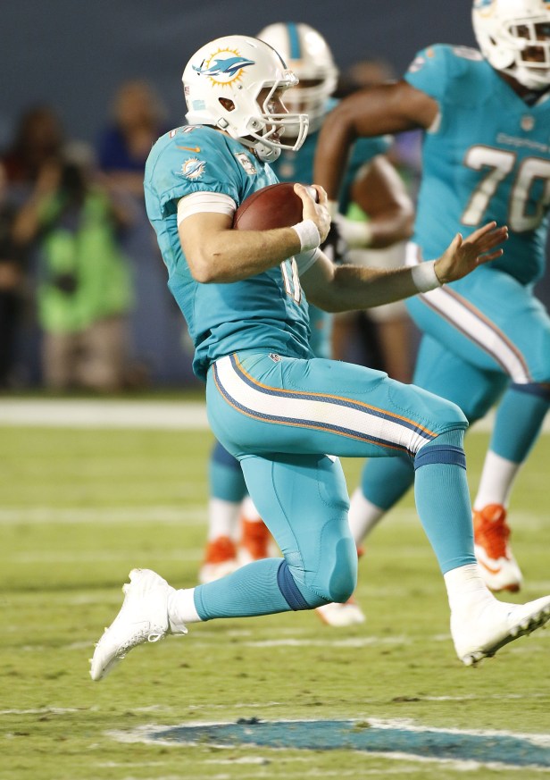 Miami Dolphins quarterback Ryan Tannehill slides during a game.