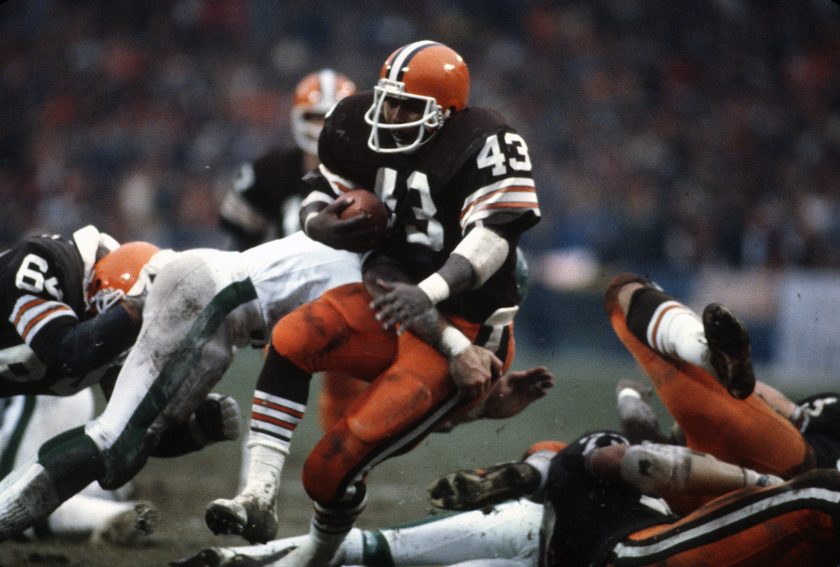 A Cleveland Browns running back gets tackled during a game.