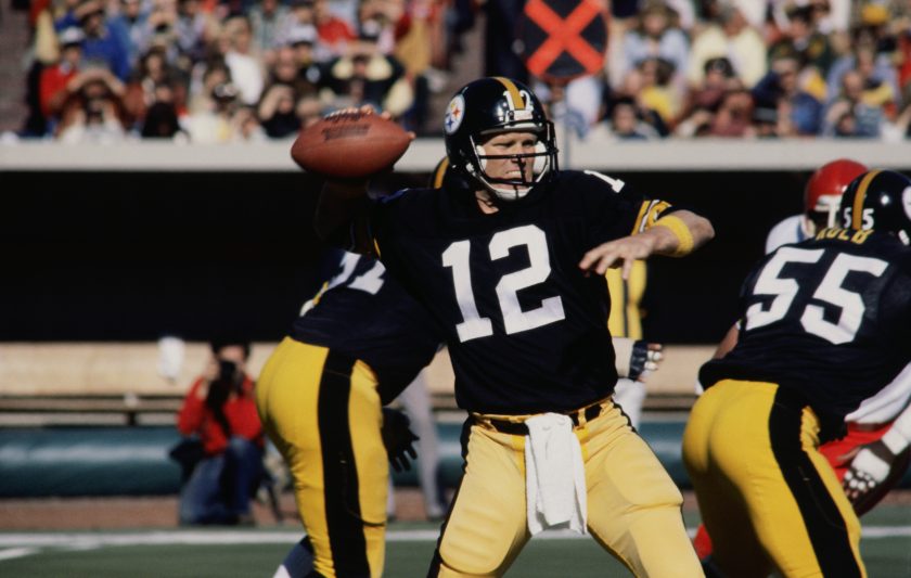Pittsburgh Steelers' quarterback Terry Bradshaw prepares to throw a pass to one of his fellow teammates.