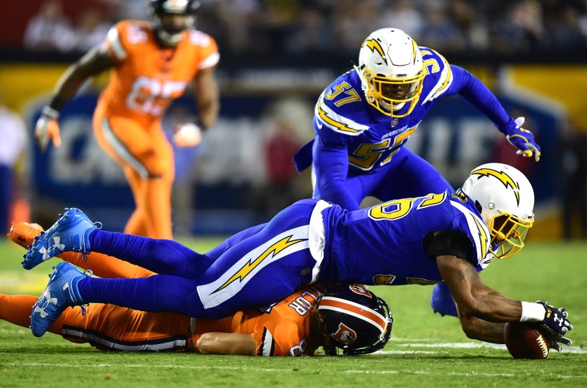 San Diego Chargers players dive for the ball.