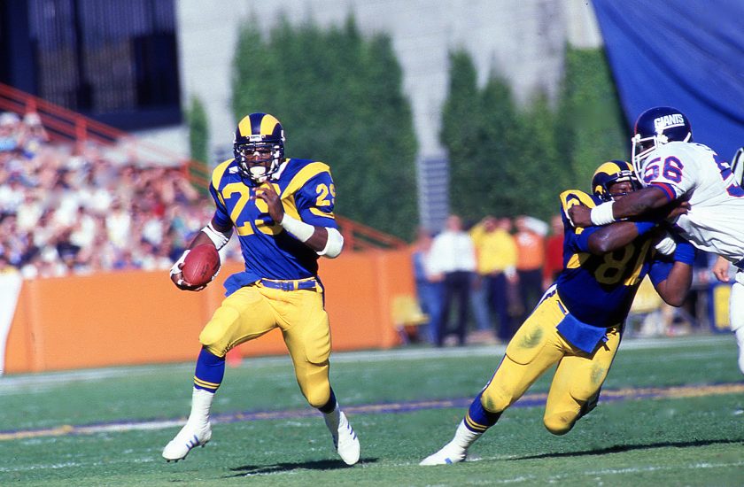 Los Angeles Rams RB Eric Dickerson sprints with the ball during a game.
