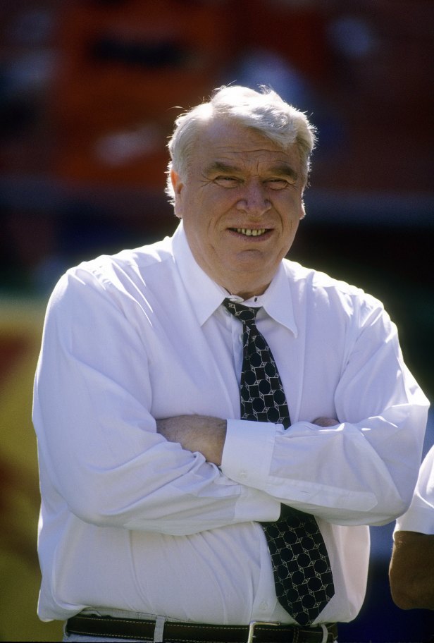 NFL Analyst John Madden ming;es on the field prior to a game.