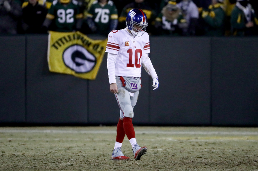 New York Giants QB Eli Manning hangs his head during a playoff matchup against the Green Bay Packers.