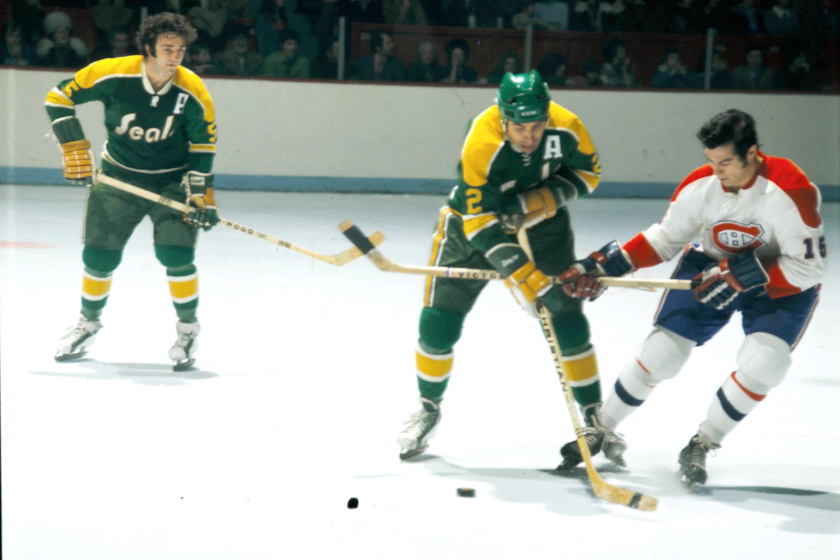 The Golden Seals and Montreal Canadeins battle for a loose puck.
