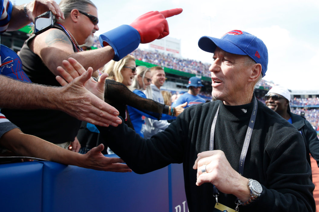 Former Buffalo Bills quarterback Jim Kelly engages with fans before watching a game against the New England Patriots at New Era Field