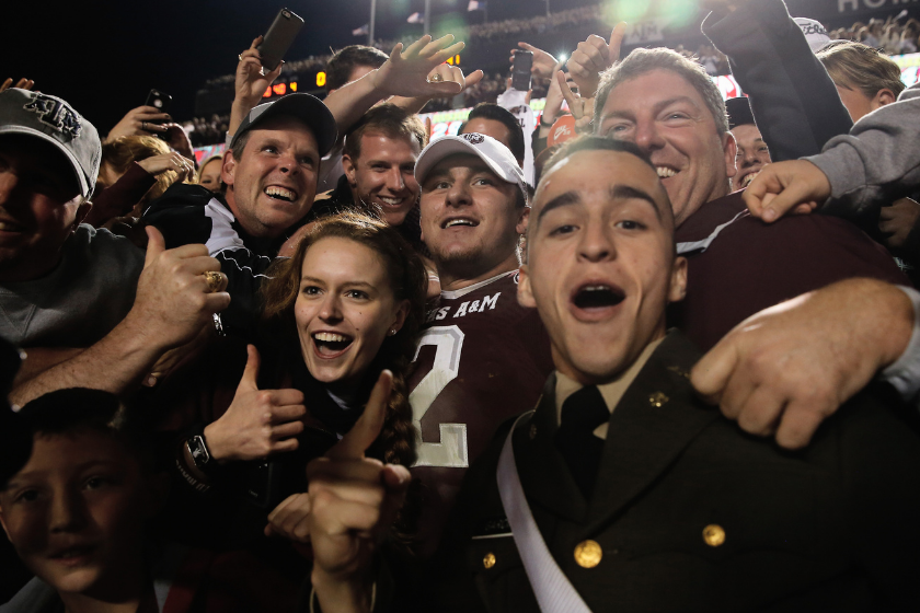Texas A&M QB Johnny Manziel celebrates with fans after beating Mississippi State.