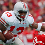 Running back Maurice Clarett smiles as he holds up a Denver