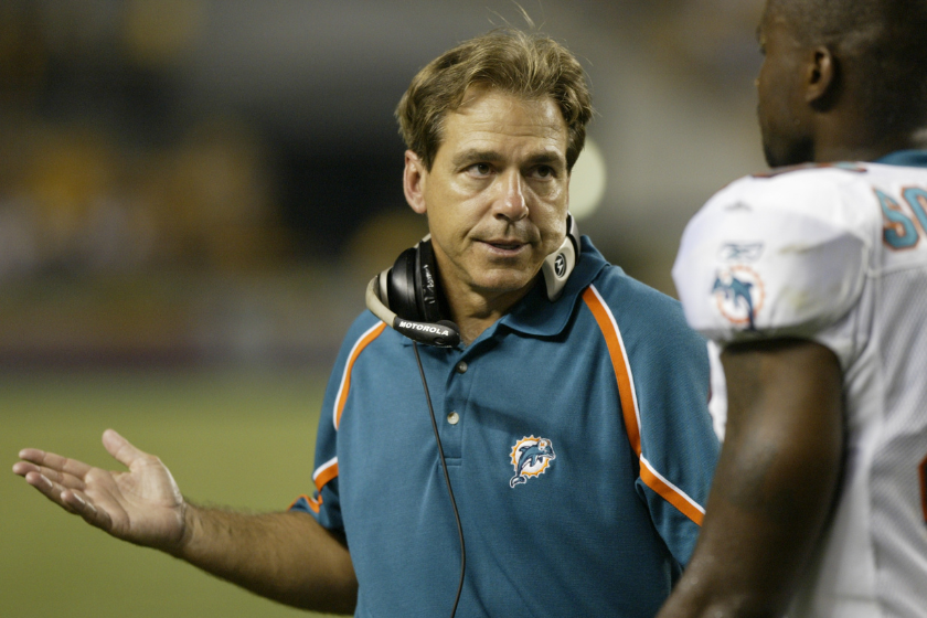 Head coach Nick Saban of the Miami Dolphins talks with a player on the sideline during a preseason game 