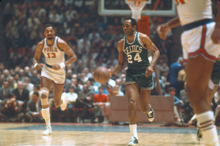 Sam Jones takes the ball up court against the Philadelphia 76ers.