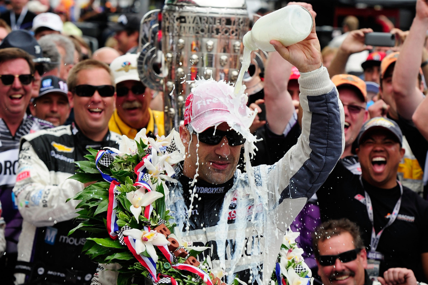 Tony Kanaan pours milk over his head as he celebrates in victory circle after winning the 2013 indy 500
