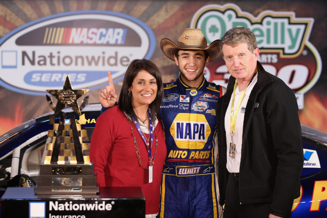 Chase Elliott celebrates in victory lane after winning his parents Cindy (L) and Bill (R) the NASCAR Nationwide Series O'Reilly Auto Parts 300 at Texas Motor Speedway on April 4, 2014 in Fort Worth, Texas