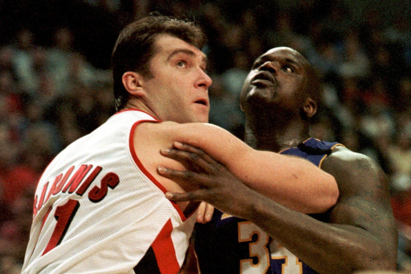 Arvydas Sabonis and Shaquille O'Neal fight for a rebound.