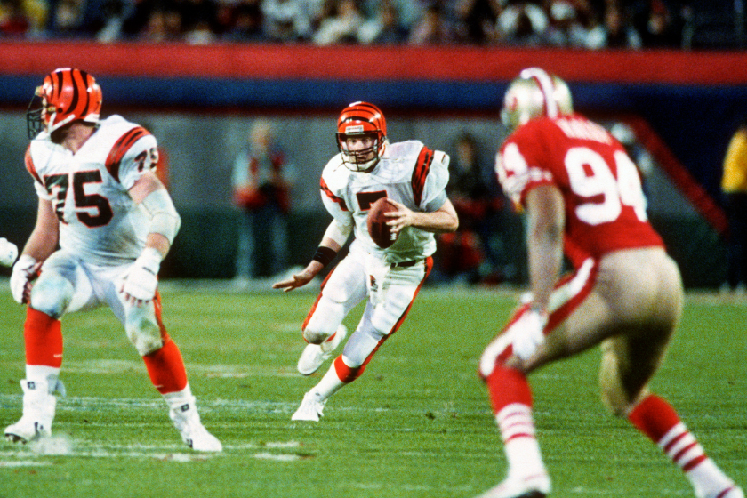 Boomer Esiason scrambles against the San Francisco 49ers in Super Bowl XXXIII.