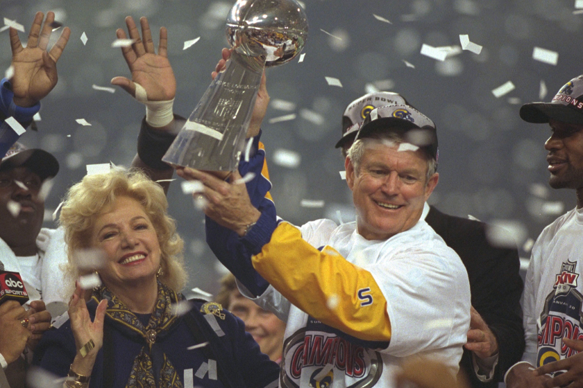 head coach Dick Vermeil holding the Vince Lombardi Trophy at Super Bowl XXXIV on Jan. 30, 2000 in Atlanta