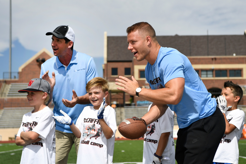 Ed and Christian McCaffrey at their family football camp. 