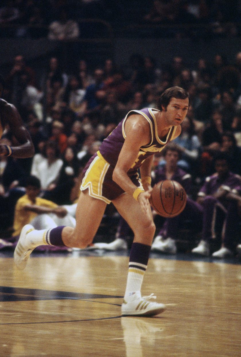 Jerry West dribbles the ball during a game.