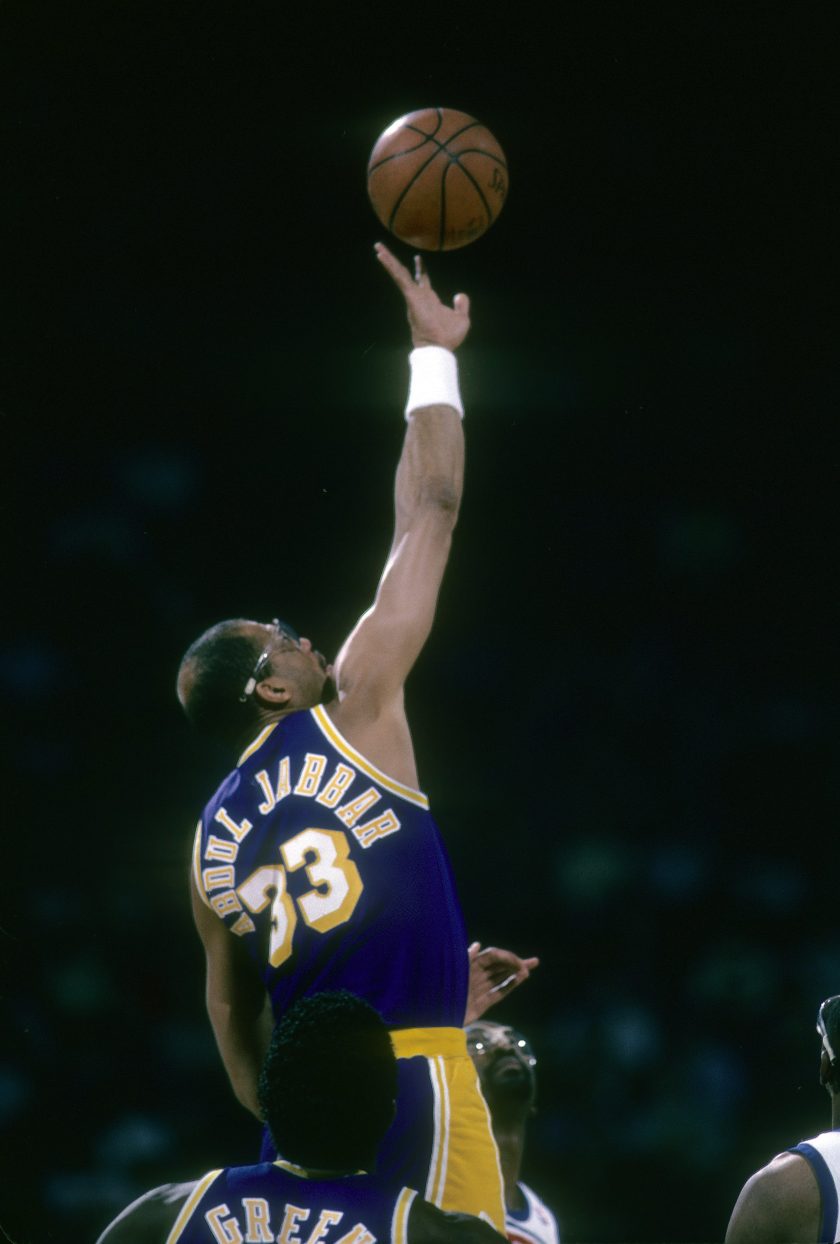 Kareem Abdul-Jabbar tips the ball during an NBA game.