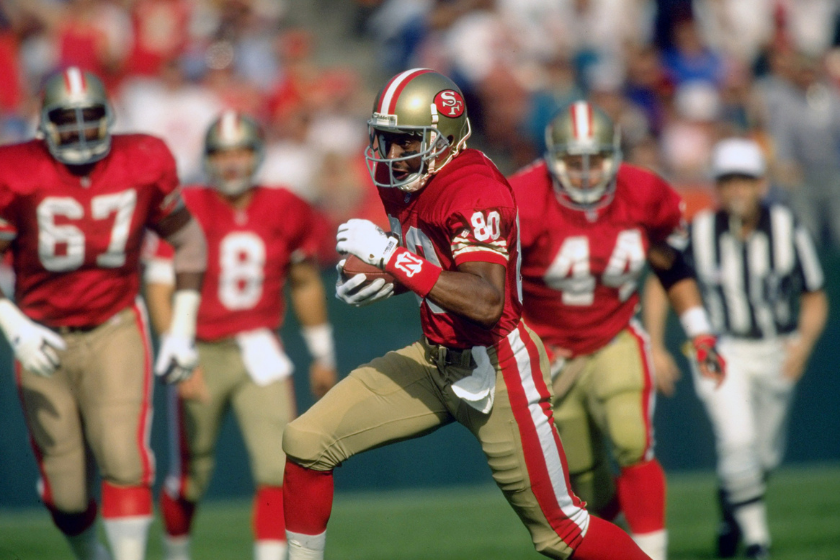 Jerry Rice runs after the catch against the New Orleans Saints.