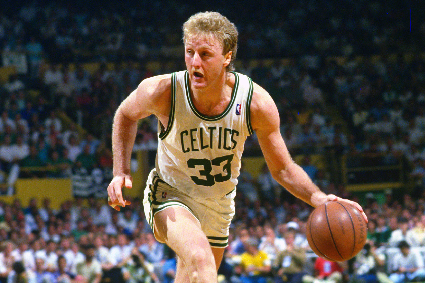 Larry Bird takes the ball up court for the Boston Celtics