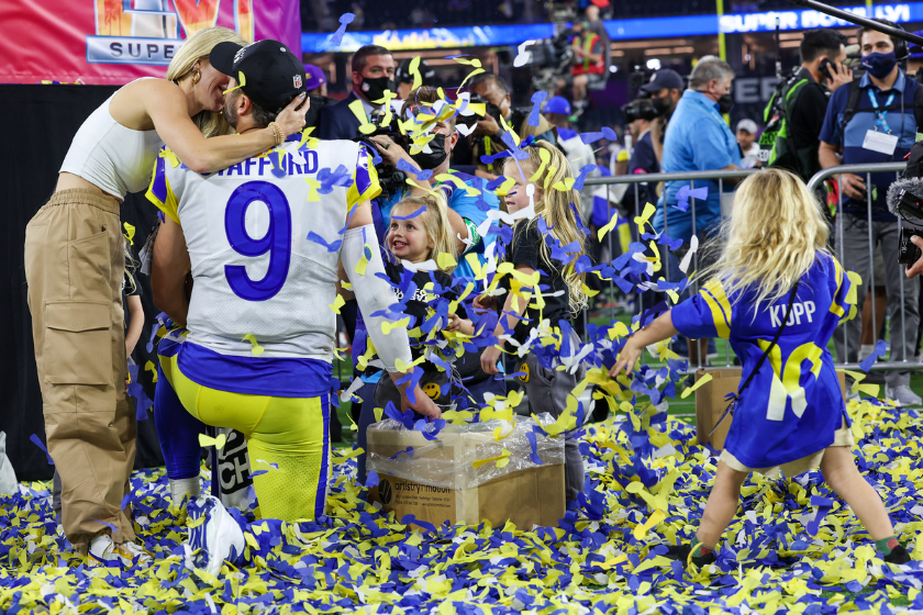 Rams quarterback Matthew Stafford is embraced by his wife, Kelly as their children frolic in confetti after beating the Cincinnati Bengals in Super Bowl LVI 
