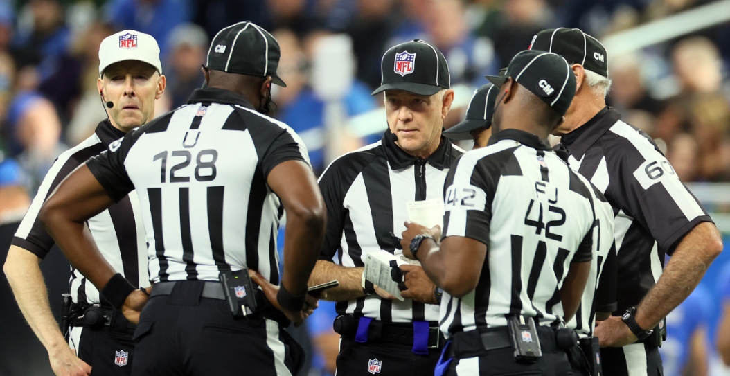 NFL referees circling up during a game between the Green Bay Packers and Detroit Lions.