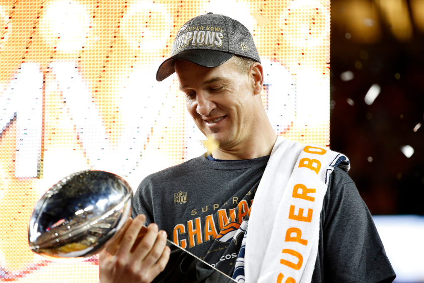 Peyton Manning #18 of the Denver Broncos looks at the Vince Lombardi Trophy after Super Bowl 50 at Levi's Stadium