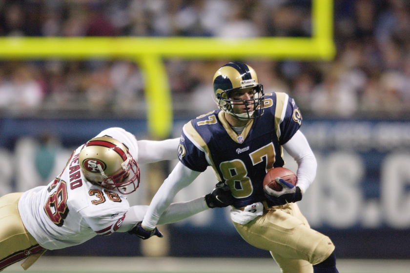 Ricky Proehl attempts to break a tackle against the San Francisco 49ers.