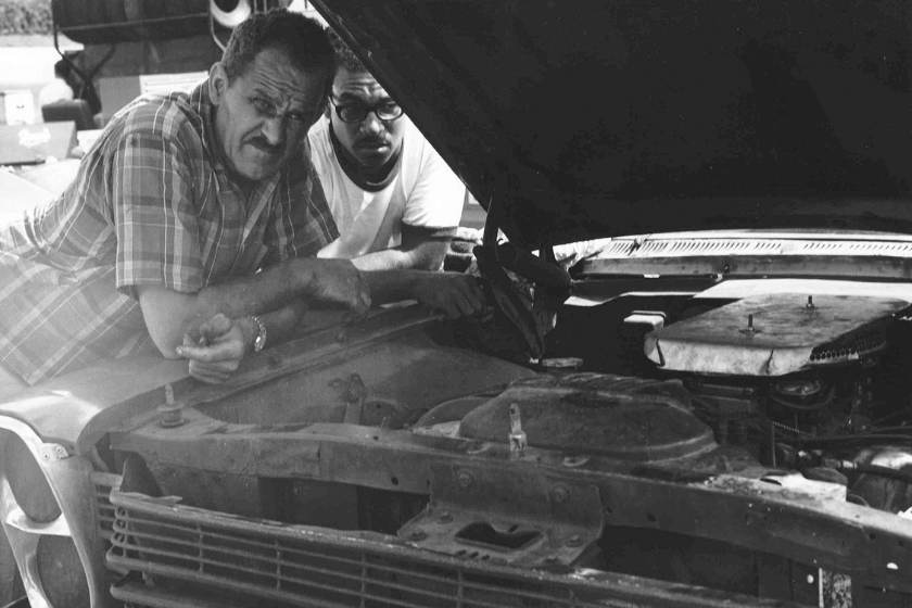 Wendell Scott checks over the engine of his 1966 NASCAR Cup Ford at a race in the mid-60s
